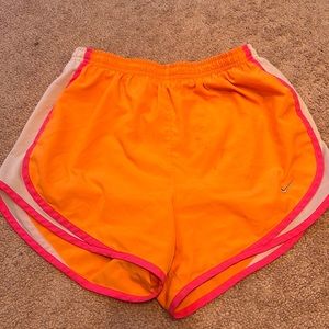 Neon orange Nike athletic shorts